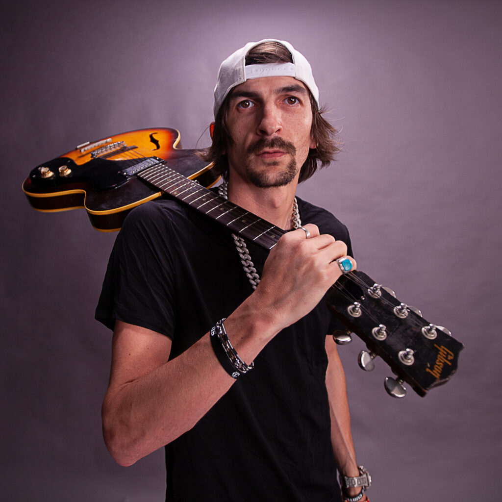 Image of man holding guitar